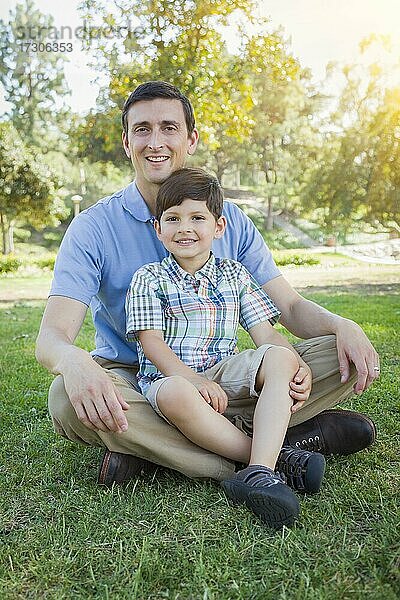 Handsome gemischtrassigen Vater und jungen Sohn Porträt im Park
