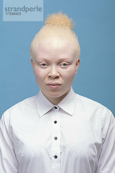 Studio-Porträt einer Albino-Frau im weißen Hemd