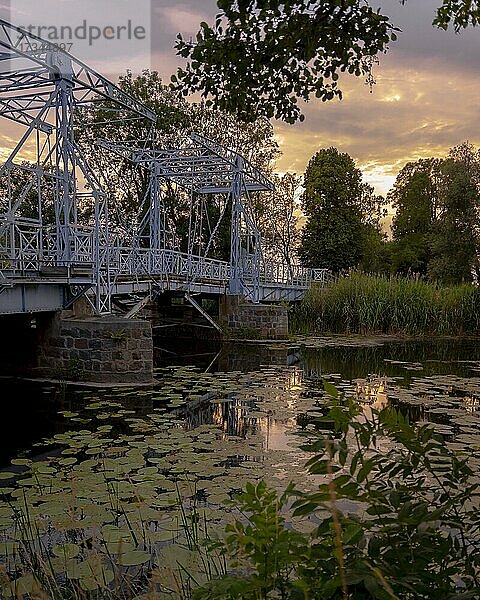Zugbrücke über den Fluss Tyna. Sonnenuntergang Dorf Jezioro  Thiendorf  Polen  Europa