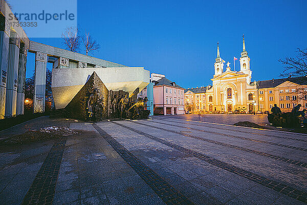 Polen  Masowien  Warschau  Stadtplatz mit Denkmal des Zweiten Weltkriegs und beleuchteter Kathedrale