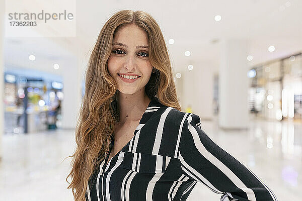Lächelnde junge Frau in einem Einkaufszentrum