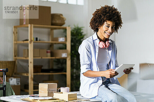 Lächelnde Geschäftsfrau mit digitalem Tablet im Studio
