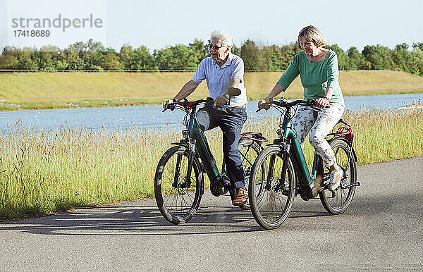 Älteres Paar fährt Fahrrad auf der Straße