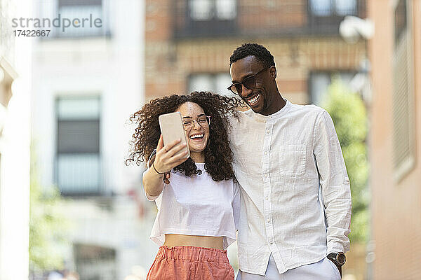 Glückliche Männer und Frauen machen Selfies mit dem Smartphone
