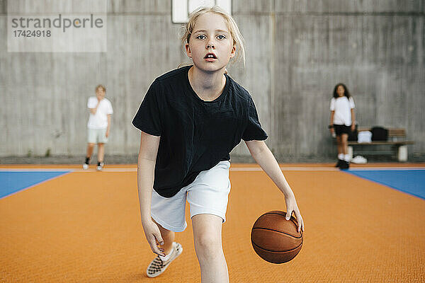 Porträt einer Basketballspielerin beim Üben auf dem Sportplatz