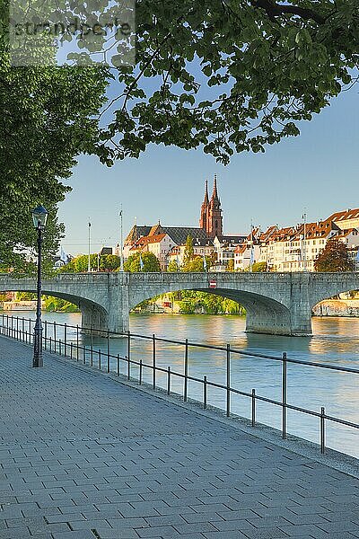 Blick vom Rheinufer entlang der Flusspromenade auf die Altstadt von Basel mit dem Basler Münster  der Martins Kirche  der Mittlere Brücke und dem Rhein Fluss
