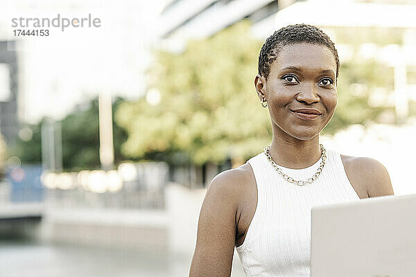 Lächelnde Geschäftsfrau mit Laptop