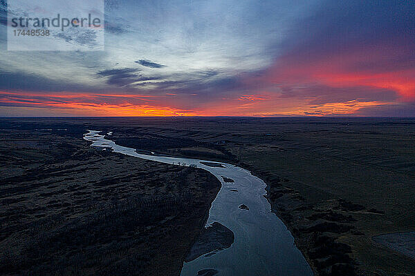 Neonroter Sonnenuntergang über dem Red Deer River