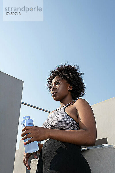 Starke afroamerikanische Sportlerin mit Wasser