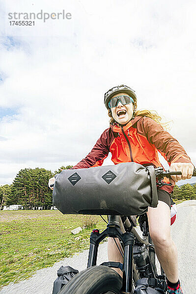 Frau genießt mit dem Mountainbike die Natur und übt Bikepacking