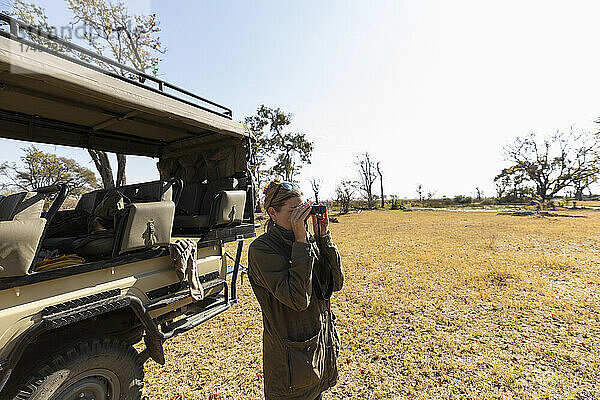 Frau mit Fernglas  Okavango-Delta  Botswana
