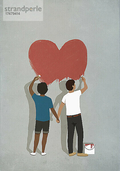 Paar hält sich an den Händen und malt ein Herz an die Wand