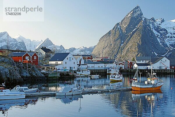 Traditionelle Fischerboote im Hafen von Hamnoy  Rorbuer  schneebedeckte Berge im Winter  Nordland  Lofoten  Skandinavien  Norwegen  Europa
