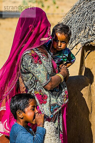 Farbenfroh gekleidete Wüstenbewohner  Lehmhütten-Siedlung in der Wüste Thar  Wüste Thar  Rajasthan  Indien  Asien
