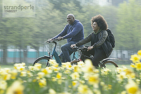 Glücklicher Vater und Sohn beim Fahrradfahren im Frühlingspark