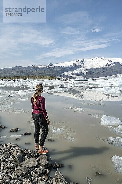Frau steht vor Eislagune Fjallsárlón  Eisschollen vor Gletscher Vatnajökull  Hornafjörður  Island  Europa