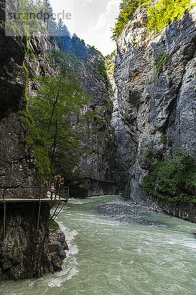 Mother hiking with daughter and son on footpath at Aare gorge in Meiringen  Bernese Oberland  Switzerland