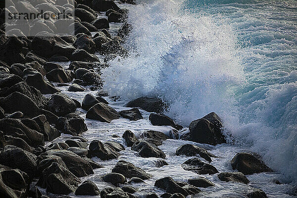 Wellen plätschern gegen die felsige Küste von Praia de Santa Barbara