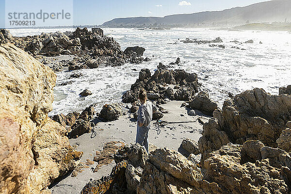 Zwei Kinder erkunden die zerklüfteten Felsen und die Atlantikküste.