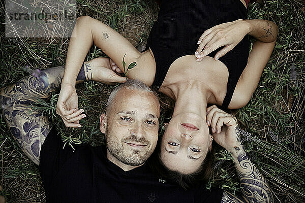 Smiling couple lying on lavender field