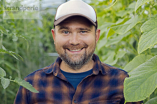 Portrait of smiling farmer in a greenhouse