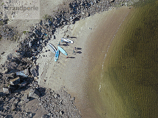 Aerial view of surfers on sandy bank of Teriberka River