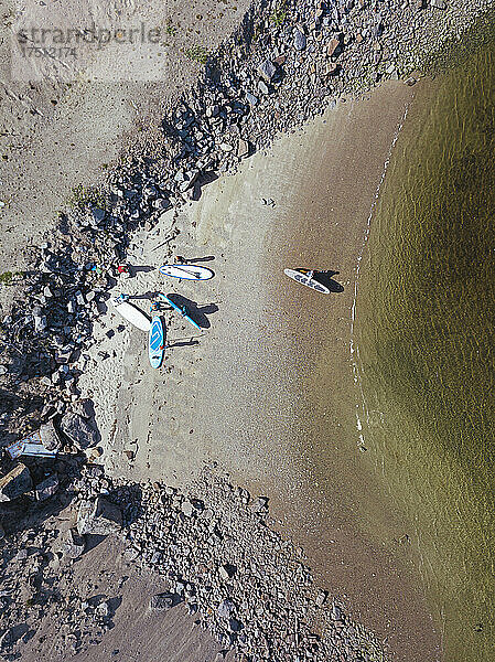 Aerial view of surfers on sandy bank of Teriberka River