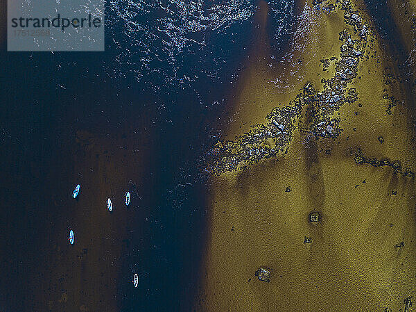 Aerial view of surfers in Teriberka River