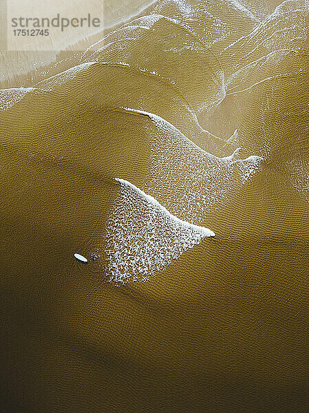 Aerial view of female surfer on sandy coastal beach of Barents Sea