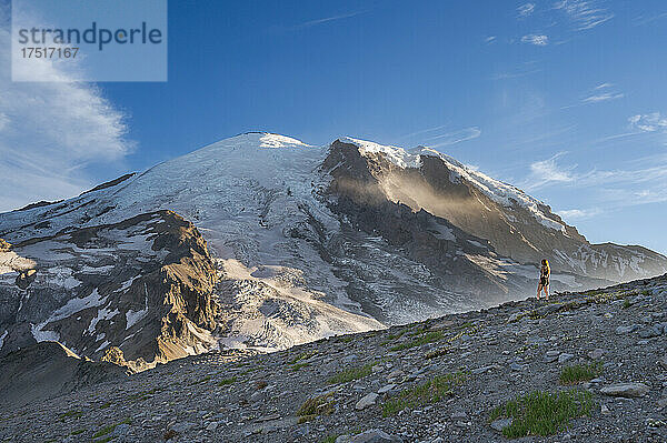 Fitte Frau steht auf einem Bergrücken neben dem Mount Rainier