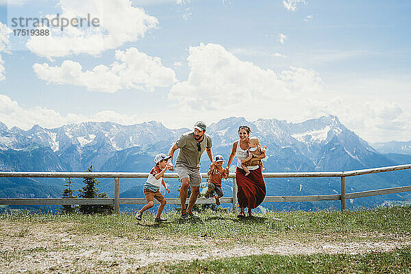 Große Familie vergnügt sich im Sommer in den Alpen