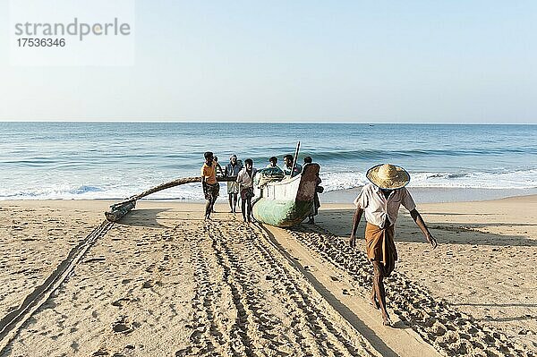 Fischer ziehen Fischerboot aus dem Meer an den Sandstrand  Einbaum mit Ausleger  Darwins Beach  Wella Odaya bei Ranna  Südprovinz  Sri Lanka  Indischer Ozean  Asien