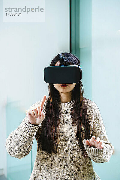 Young woman with long hair wearing virtual reality headset