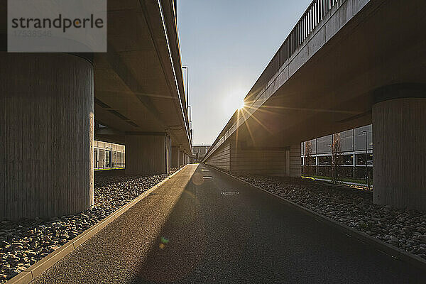 Germany  Brandenburg  Schonefeld  Sun setting over elevated roads at Berlin Brandenburg Airport