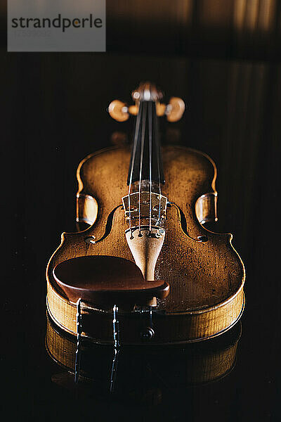 Studio shot of violin lying against black background