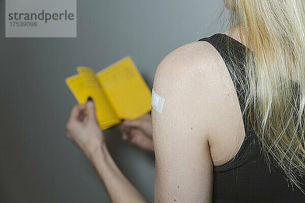 Blond woman with adhesive bandage on arm
