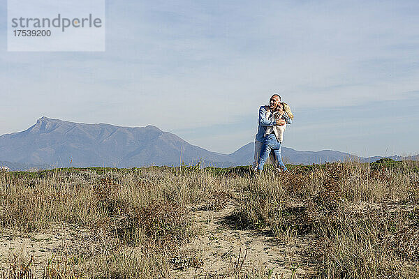 Carefree couple embracing at dunes
