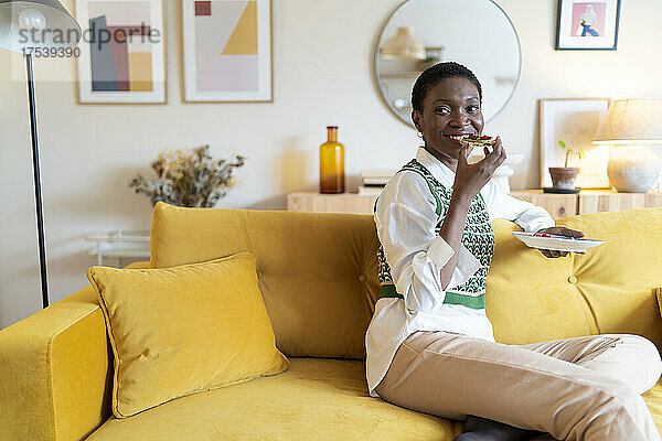 Happy woman enjoying breakfast being at home