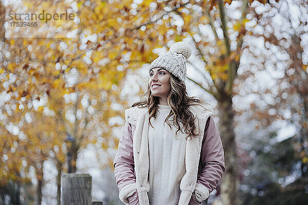 Woman wearing warm clothing standing in park