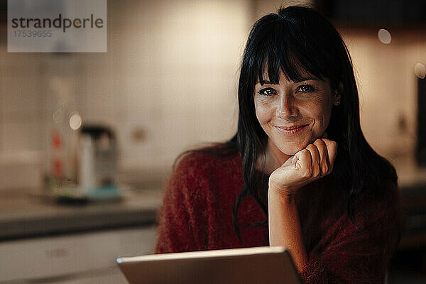 Happy woman with tablet PC at home