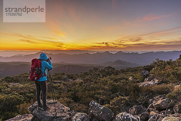 Australia  Victoria  Female tourist taking pictures from Mount William at sunset