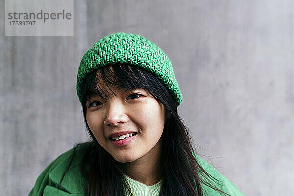 Smiling woman wearing green knit hat