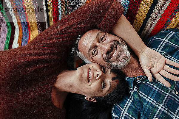 Smiling mature couple resting at home