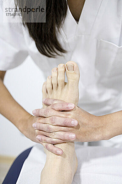 Physiotherapeut massiert Fußpilz im Rehabilitationszentrum