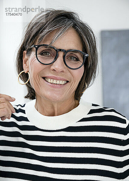 Happy mature businesswoman wearing eyeglasses
