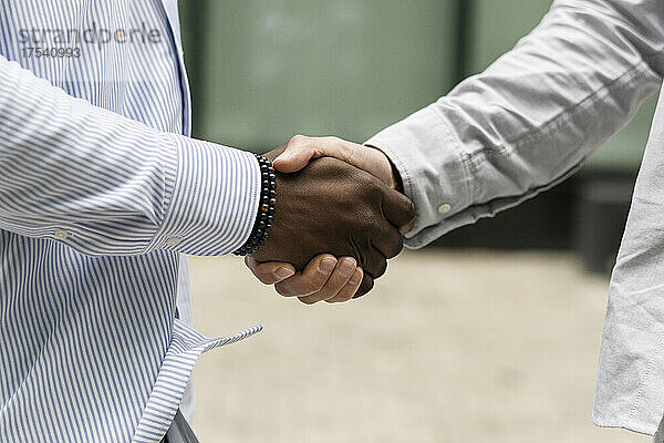 Multiracial friends doing handshake
