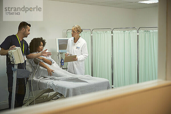 Krankenschwester und Patient diskutieren mit Arzt im Krankenzimmer des Krankenhauses
