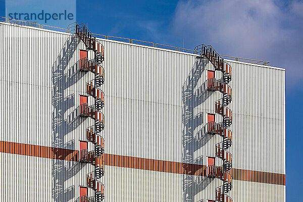 Germany  Bremen  Pair of spiral fire escapes outside industrial warehouse