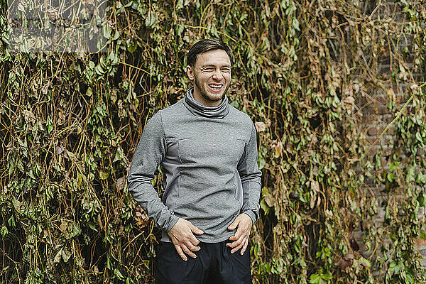 Happy sportsman in front of dry plants