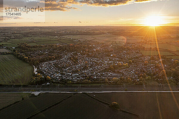 UK  England  Whittington  Aerial view of countryside town at sunset
